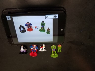 This photo shows images of superheroes on a tablet screen