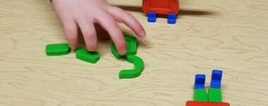 this photo shows a child who is using the Groovy People toy to build a matching figure of a person.