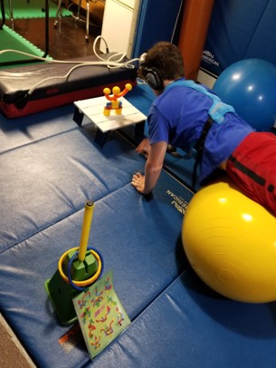 This photo shows a youngster building one of the magnetic building block  projects shown on an instruction sheet while he walks forward on his hands to complete a  physioroll  walkout