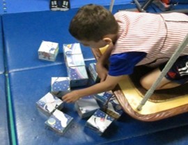 This photo shows  a child working on a block puzzle 