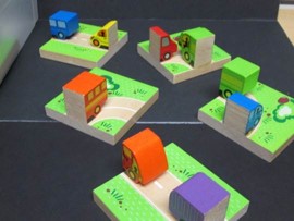 This photo shows  a group of car/truck dominoes