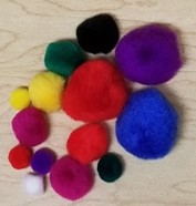 The above photo shows an assortment of pompoms in different colors and sizes