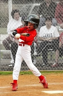 the photo shows a youngster mid swing at bat